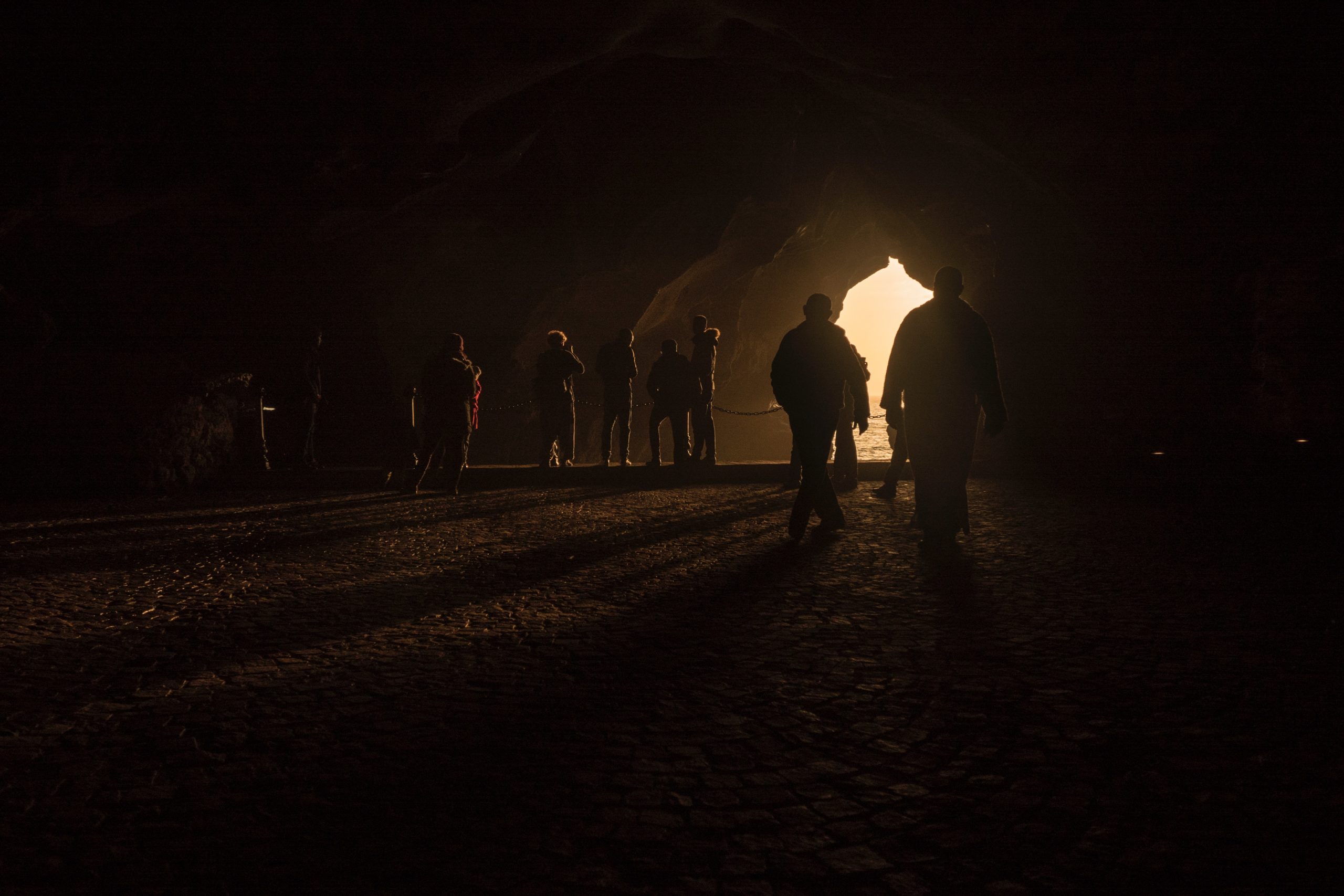 Silhouettes of people in a cave